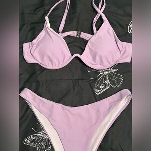 Lilac purple bikini, barley worn, size- L, comes with a tie skirt.